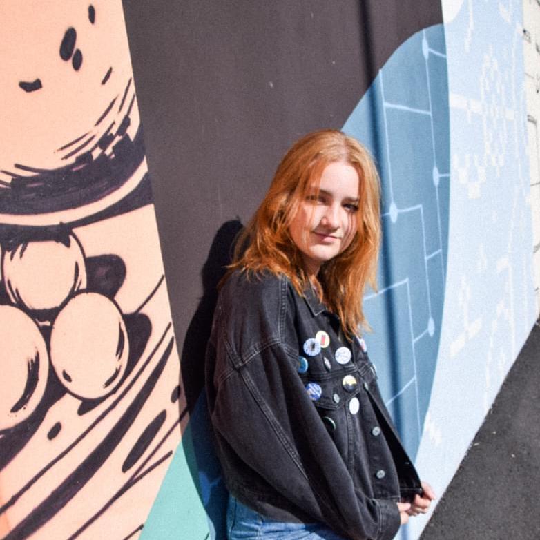 Model image of girl posing with a jacket that has Foxi buttons on them